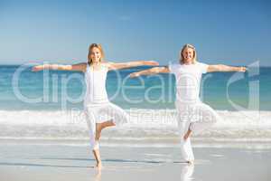 Man and woman performing yoga