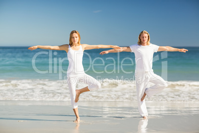 Man and woman performing yoga