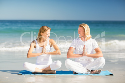 Man and woman performing yoga