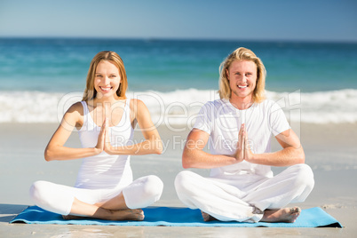 Man and woman performing yoga