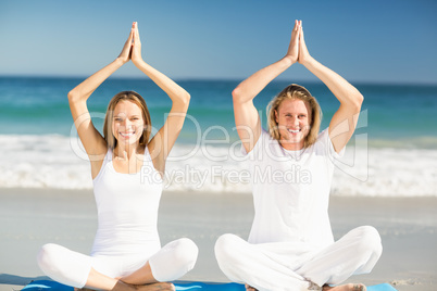 Man and woman performing yoga