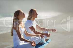 Man and woman performing yoga