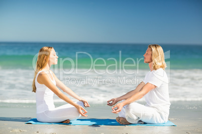 Man and woman performing yoga