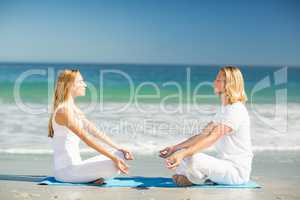 Man and woman performing yoga