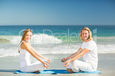 Man and woman performing yoga