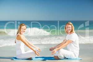 Man and woman performing yoga