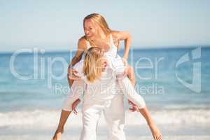 Man giving piggy back ride to woman