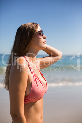 Woman in bikini posing with sunglasses