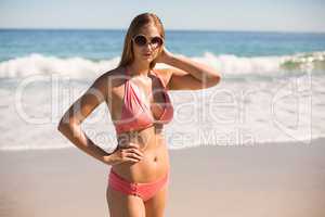 Woman in bikini posing with sunglasses