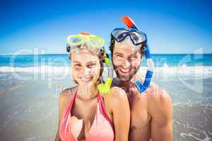 Couple wearing diving mask on beach
