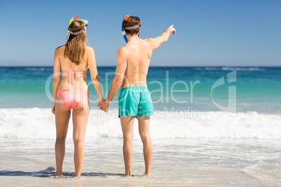 Couple holding hands on beach