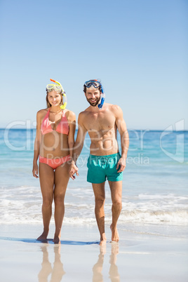 Couple holding hands on beach