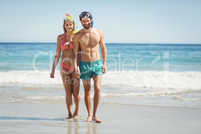 Couple holding hands on beach