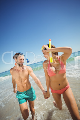 Couple running in water