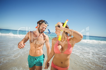 Happy couple walking on beach