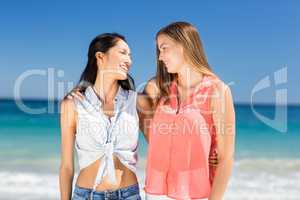 Young female friends looking at each other