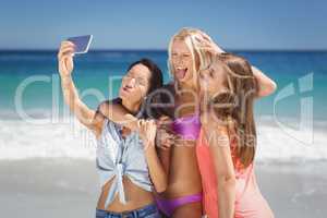 Young female friends taking selfie