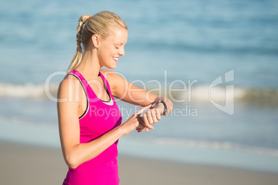 Woman checking time on beach