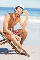 Young man sitting on armchair