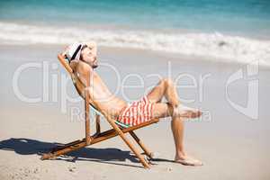 Young man relaxing on armchair