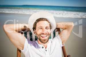 Young man relaxing on armchair