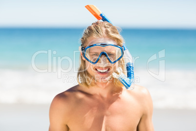 Man wearing diving mask on beach