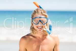 Man wearing diving mask on beach