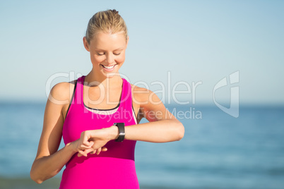 Woman checking time on beach