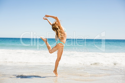 Woman jumping on the beach