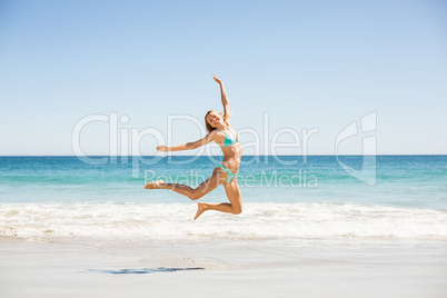 Woman jumping on the beach