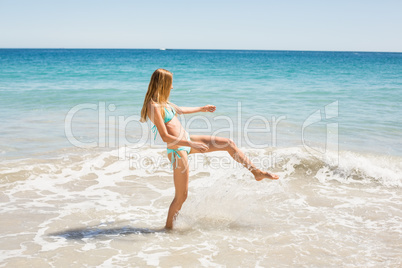 Young woman playing in water