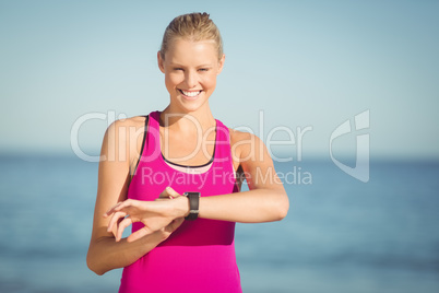 Woman checking time on beach