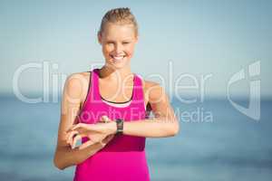 Woman checking time on beach