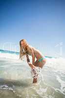 Young woman playing in water