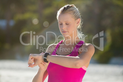 Woman checking time on beach