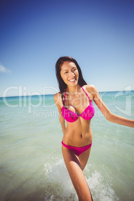 Attractive woman walking in water