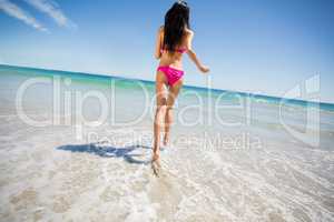 Attractive woman running on beach