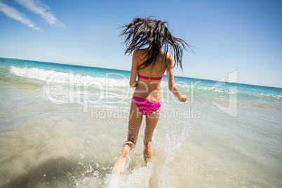 Attractive woman running in water