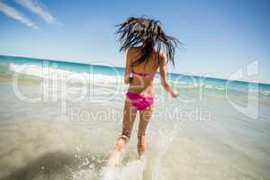 Attractive woman running in water
