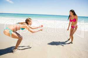 Female friends playing on beach