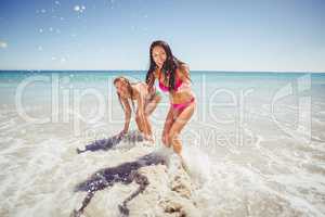 Female friends playing on beach