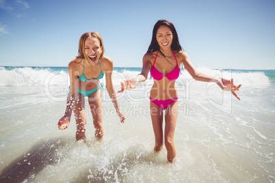 Female friends playing on beach