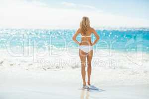 Woman in bikini standing on beach