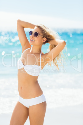 Woman wearing bikini posing with sunglasses