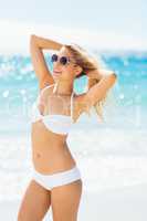 Woman wearing bikini posing with sunglasses