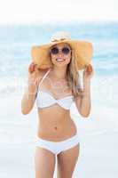 Attractive woman in bikini posing on beach