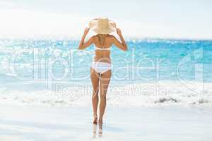 Woman in bikini walking on beach