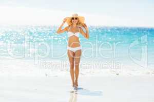 Woman in bikini posing with hat