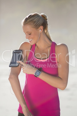 Woman listening music on mobile phone