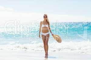 Woman in bikini walking on beach